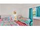 Charming bedroom with two twin beds and vibrant decor at 3934 Aquilla Dr, Lakeland, FL 33810