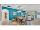 Stylish dining room featuring a teal accent wall, modern lighting, and an open-concept layout for entertaining at 3934 Aquilla Dr, Lakeland, FL 33810