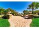 A serene water fountain is surrounded by brick pavers, manicured lawns, palm trees and decorative planters at 3934 Aquilla Dr, Lakeland, FL 33810