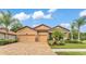 Beautiful home featuring a brick driveway, a two-car garage, and manicured landscaping at 3934 Aquilla Dr, Lakeland, FL 33810
