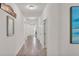 Inviting hallway with wood-look flooring and white walls at 3934 Aquilla Dr, Lakeland, FL 33810