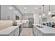 Modern kitchen boasts stainless steel appliances, stylish gray cabinets, pendant lighting, and pristine quartz countertops at 3934 Aquilla Dr, Lakeland, FL 33810