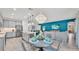 Bright, open floorplan featuring a kitchen with island seating, dining area, and living space with teal accent wall at 3934 Aquilla Dr, Lakeland, FL 33810