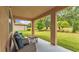 Cozy covered patio overlooking a well-maintained backyard, perfect for relaxing or entertaining at 3934 Aquilla Dr, Lakeland, FL 33810