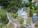 An aerial view showcasing the home's roof, in-ground pool, driveway, and surrounding greenery at 4006 Glen Garry W Rd, Lakeland, FL 33813