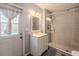 Bathroom with a glass enclosed shower, neutral paint, and a door that goes to the pool area at 4006 Glen Garry W Rd, Lakeland, FL 33813