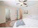 Bright bedroom showcasing an open ensuite bathroom and closet with hardwood floors and ceiling fan at 4006 Glen Garry W Rd, Lakeland, FL 33813