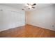 Bedroom boasting wood flooring, a closet, and natural light from a window at 4006 Glen Garry W Rd, Lakeland, FL 33813