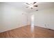 Bedroom featuring wood floors, a closet, a ceiling fan, and a door to another room at 4006 Glen Garry W Rd, Lakeland, FL 33813