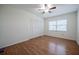 Bedroom featuring a closet, wood floors, a window, and a ceiling fan at 4006 Glen Garry W Rd, Lakeland, FL 33813