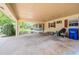 Wide carport with a view of the landscaped yard, screened in porch, and house exterior at 4006 Glen Garry W Rd, Lakeland, FL 33813