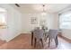 Dining area featuring a glass-top table, seating for four, and wood flooring at 4006 Glen Garry W Rd, Lakeland, FL 33813