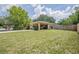 Single story home with light colored exterior, long driveway, covered carport, and a wooden fence at 4006 Glen Garry W Rd, Lakeland, FL 33813