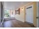 Charming front porch with wood floors, leading to the entrance of the house and a screened in porch at 4006 Glen Garry W Rd, Lakeland, FL 33813
