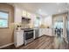 Charming kitchen features wood flooring, stainless steel appliances, and bright white cabinetry at 4006 Glen Garry W Rd, Lakeland, FL 33813