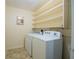 Bright laundry room features side by side washer and dryer and built in shelving at 4006 Glen Garry W Rd, Lakeland, FL 33813