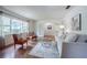 Inviting living room with wood floors, a large window, comfortable seating, and bright, airy feel at 4006 Glen Garry W Rd, Lakeland, FL 33813