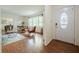 Bright living room with hardwood floors, a large front window, and views of the dining room at 4006 Glen Garry W Rd, Lakeland, FL 33813