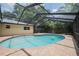 Inviting backyard pool with a screened-in enclosure and brick paver surround, ideal for enjoying outdoor living at 4006 Glen Garry W Rd, Lakeland, FL 33813