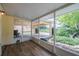Relaxing screened porch with wood floors and a view of the backyard and spacious carport at 4006 Glen Garry W Rd, Lakeland, FL 33813