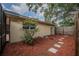 Mulched side yard featuring stepping stones and a wooden privacy fence at 4006 Glen Garry W Rd, Lakeland, FL 33813