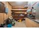 Functional storage room with wood paneling and convenient shelving for organized storage of household items at 4006 Glen Garry W Rd, Lakeland, FL 33813