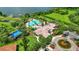 Stunning aerial view of the community pool, lush landscaping, and elegant home with a tile roof at 4088 Prima Lago Cir, Lakeland, FL 33810