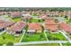 Aerial view of homes with tile roofs, lush lawns, and backyard patios; ideal for comfortable, outdoor living at 4088 Prima Lago Cir, Lakeland, FL 33810