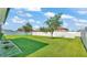 Spacious backyard featuring a well-maintained lawn, privacy fence, and mature trees, ideal for relaxation and outdoor activities at 4088 Prima Lago Cir, Lakeland, FL 33810