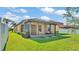 Home's backyard featuring a covered patio and well-maintained lawn, perfect for outdoor living and relaxation at 4088 Prima Lago Cir, Lakeland, FL 33810
