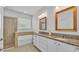 Spacious bathroom with dual vanities, soaking tub, and glass-enclosed shower at 4088 Prima Lago Cir, Lakeland, FL 33810