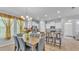Bright, open kitchen features white cabinets, stainless appliances, and breakfast bar seating at 4088 Prima Lago Cir, Lakeland, FL 33810