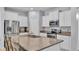 Modern kitchen features white cabinetry, stainless steel appliances, and granite countertops at 4088 Prima Lago Cir, Lakeland, FL 33810