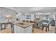 Open-concept kitchen with a center island, granite countertops, and a view of the dining and living area at 4088 Prima Lago Cir, Lakeland, FL 33810