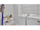 Laundry area showcasing a washing machine, dryer, and storage shelf offering functionality and organization at 4088 Prima Lago Cir, Lakeland, FL 33810