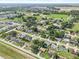 Aerial view of a community with tree lined streets and houses with large lawns at 4219 Sunny Land Dr, Lakeland, FL 33813