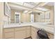 Bright bathroom featuring a dual sink vanity, large mirror, and convenient access to the shower at 4219 Sunny Land Dr, Lakeland, FL 33813