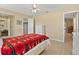 Well-lit bedroom with tile flooring, comfortable bed, and easy access to the closet and bathroom at 4219 Sunny Land Dr, Lakeland, FL 33813