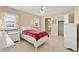 Cozy bedroom featuring tile floors, a comfortable bed and an adjacent bathroom and closet at 4219 Sunny Land Dr, Lakeland, FL 33813