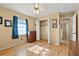 Bedroom with hardwood flooring, ceiling fan and closet; decorated with blue curtains and natural lighting at 4219 Sunny Land Dr, Lakeland, FL 33813