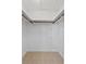Walk-in closet with tiled floor, ample hanging space, and minimalist design at 4219 Sunny Land Dr, Lakeland, FL 33813
