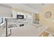 Bright and airy kitchen with white appliances, breakfast bar and adjoining laundry room at 4219 Sunny Land Dr, Lakeland, FL 33813