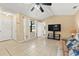 Neutral living room boasting tile flooring, natural light, and a mounted television at 4219 Sunny Land Dr, Lakeland, FL 33813