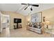 Inviting living room with neutral tones, tile flooring and a vaulted ceiling with ceiling fan at 4219 Sunny Land Dr, Lakeland, FL 33813