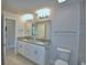 Bathroom features a double vanity with granite counters and a tiled wall, with a toilet nearby at 4300 Juliana Lake Dr, Auburndale, FL 33823
