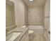 Bright bathroom with a granite countertop vanity and shower-tub combo at 4300 Juliana Lake Dr, Auburndale, FL 33823
