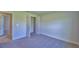 Carpeted bedroom showcasing double doors and a hallway entrance at 4300 Juliana Lake Dr, Auburndale, FL 33823