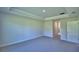 Bedroom with tray ceiling, carpeted floors, and access to other rooms at 4300 Juliana Lake Dr, Auburndale, FL 33823