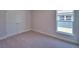 Neutral bedroom featuring a double door closet and a bright window at 4300 Juliana Lake Dr, Auburndale, FL 33823