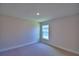 Bright bedroom featuring a window, neutral walls, and plush carpeting at 4300 Juliana Lake Dr, Auburndale, FL 33823